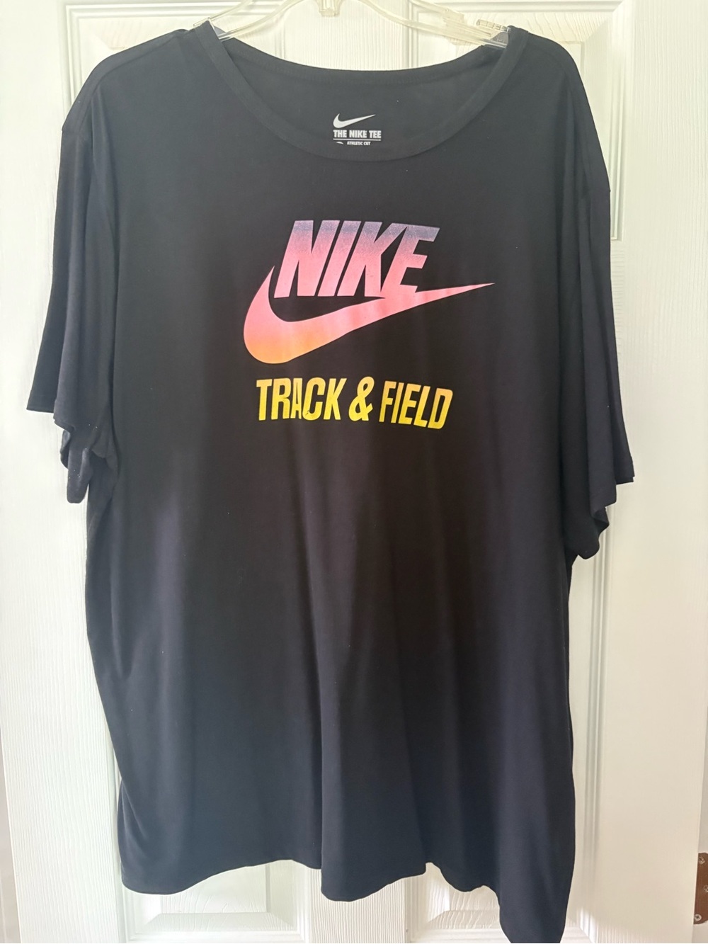 Nike Black Short Sleeve Tee with Pink-Orange Gradient Swoosh and Yellow Text